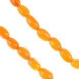 A natural amber bead necklace. Comprising a single row of forty-six graduated oval-shape natural