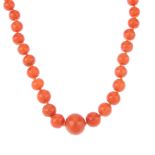 A coral necklace. A single row of graduated spherical beads, measuring 0.4 to 1cms, to the spring-