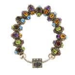 A Storywheels charm bracelet. The snake-chain bracelet with fifteen matching multi-gem charms, to