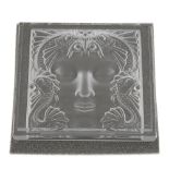 LALIQUE - an ornament. Designed as a glass square, the reverse intaglio depicting a face with sea
