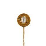 A late 19th century gold diamond stickpin. The old-cut diamond, raised to the textured halo and