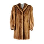 A pastel mink knee-length fur coat. Featuring a lapel collar, hook and eye clip fastenings, two