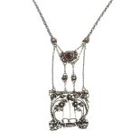 An Arts and Crafts silver garnet pendant with later added chain. Designed as a twist chain,