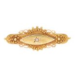 An early 20th century 15ct gold diamond brooch. The central raised panel of marquise outline, with
