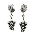 GEORG JENSEN - a pair of earrings. Designed as stylised vine leaves to the top, each suspending