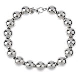 TIFFANY & CO. - a bead bracelet. Designed as uniform spherical beads strung to a fancy-link chain.