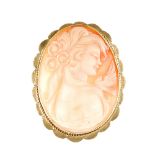 A 9ct gold cameo brooch. Of oval outline, depicting a lady in profile to the rope-twist and