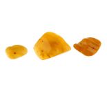 A selection of amber jewellery. To include three freeform natural amber brooches, two natural