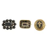 Three early 19th century brooches. The first a memorial brooch of rectangular outline, the black