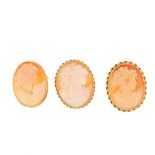 Three cameo brooches. All three shell cameos depicting ladies in profile, two with rope-twist