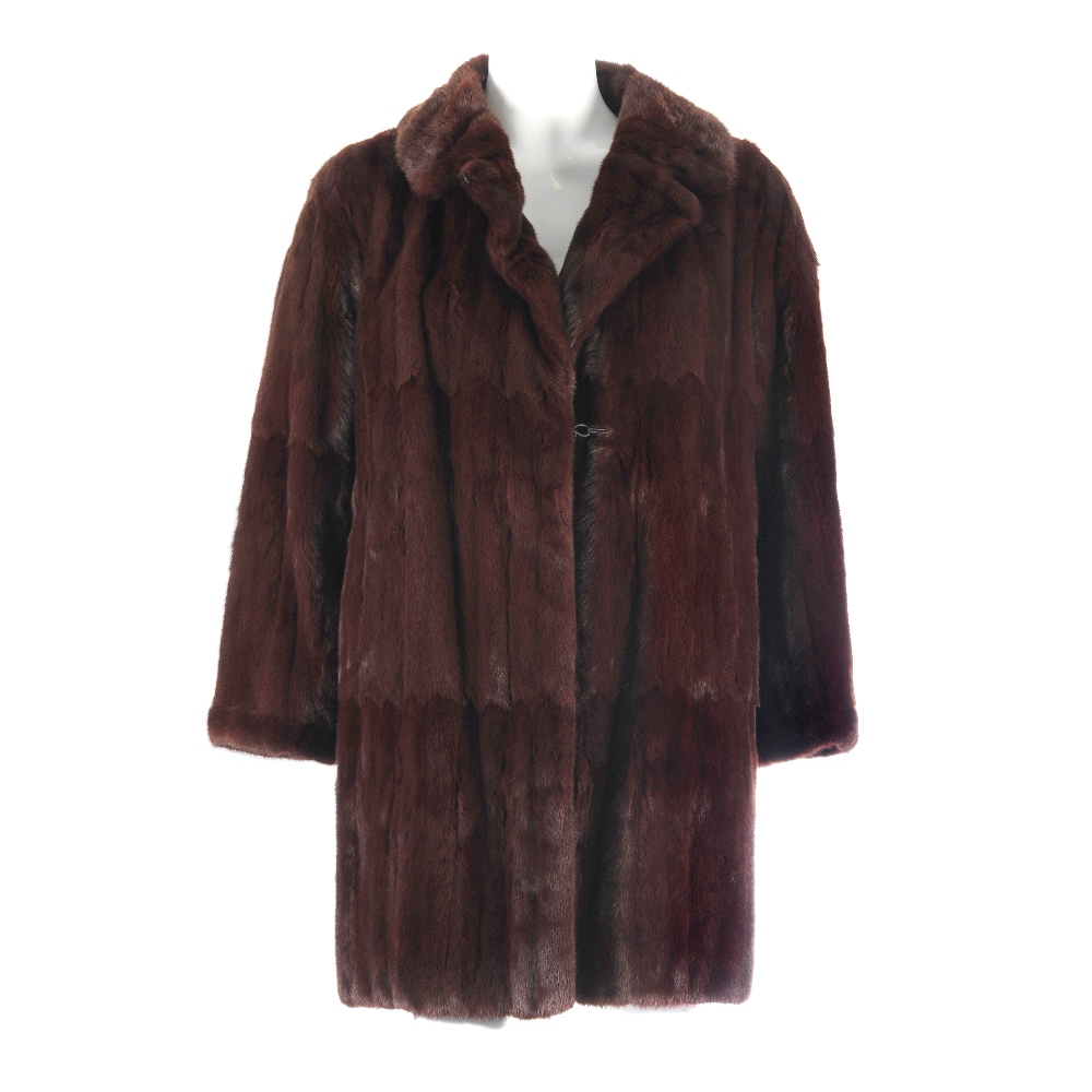 Two dyed ermine fur coats. To include a knee length coat featuring a full collar, a button