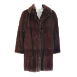 Two dyed ermine fur coats. To include a knee length coat featuring a full collar, a button