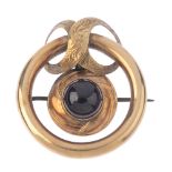 A late Victorian garnet memorial brooch. Designed as an open circle-shape with figure of eight