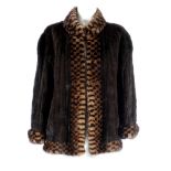 A ranch mink jacket with fur tweed collar and cuffs. Featuring a mandarin collar, hook and eye