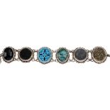 STEPHEN DWECK - a bracelet. Comprising six links, two set with dyed quartz, one with a floral carved