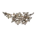 An early 20th cultured pearl and diamond brooch. Designed as a floral spray, the flowers centrally