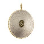 An early 19th century silver and gold locket. The oval-shape locket with engine-turned patterns