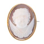 A cameo brooch. Of oval outline, the shell cameo carved in high relief to depict the face of a