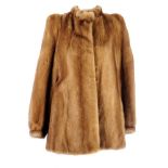 A pastel mink fur jacket. Featuring cuffed sleeves, hook and eye clip fastening, two external and