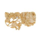 An early 20th century carved ivory brooch. Carved in the form of a rose, with other wild flowers and