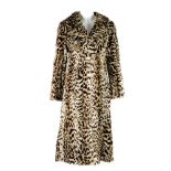 A pieced ocelot fur knee-length coat. Featuring a notched collar, hook and eye clip fastening and