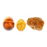 A selection of modified, reconstructed and natural amber items. To include a natural amber boulder