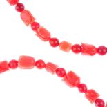 A dyed carved coral necklace. Comprising carved beads in the form of flowers, alternating with