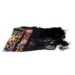 A silk embroidered black shawl. Designed as a bright floral motif covering the scarf, with knotted