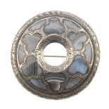 A late 19th century silver and blue lace agate Scottish brooch. Of circular outline, inlaid with