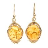 Two pairs of 9ct gold modified amber earrings. The first a pair of circular cabochon modified