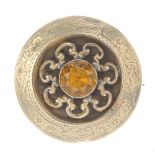 A late 19th century memorial brooch. Of circular outline, the central circular yellow paste,