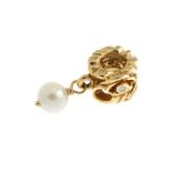 PANDORA - a gold charm. The openwork foliate design bead set with two circular diamonds,
