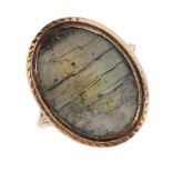 A George III memorial ring. Of oval outline the central glazed panel, to the tapering shoulders.