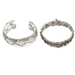 A selection of silver and white metal bangles. To include an open bangle designed as plaited strands