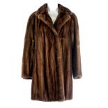 A demi-buff mink three-quarter length jacket. Featuring a notched collar, hook and eye clip