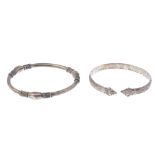 A selection of silver and white metal bangles. To include a silver hinged bangle with foliate