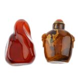 Two natural amber snuff bottles. The first a freeform polished bottle with opening to the top, the