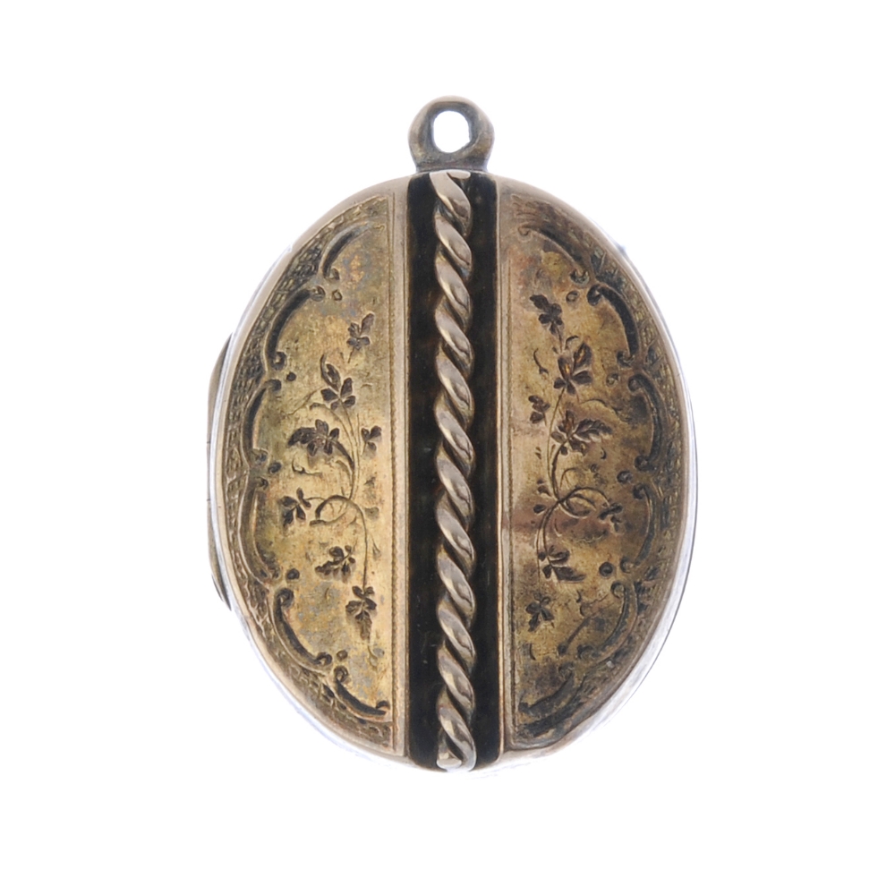 A late Victorian locket. Of oval outline, with a central rope-twist column, flanked by foliate