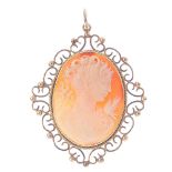 A cameo pendant. Of oval-outline, the shell carved to depict a lady in profile with a bird perched