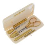 An early 20th century sewing set. The ivory case of rectangular outline with rounded corners and