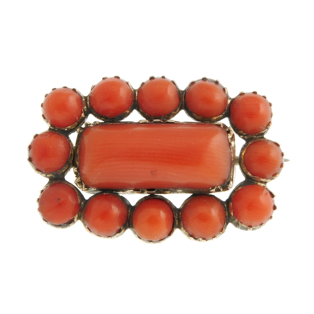 A mid Victorian coral memorial brooch. The rectangular central coral panel, with circular accents