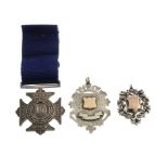 A selection of medals and medallions. To include a circular medallion, to the front an enamel red