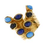YVES SAINT LAURENT - a ring. Designed as a layered band, to the protruding collet settings of blue