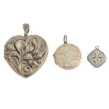 A selection of silver and white metal lockets. To include one of heart-shape with embossed flowers