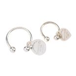 TIFFANY & CO. - two keyrings. Both designed as circular hoops, with spherical terminals, removable