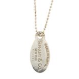 TIFFANY & CO. - a tag pendant and chain. Designed as an oval tag stamped 'Please Return to Tiffany &