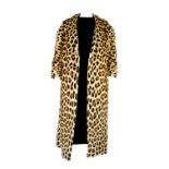 A leopard knee-length fur coat. Featuring a notched collar, two external pockets and cropped