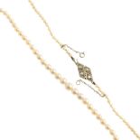 A cultured pearl necklace with gold diamond clasp. The single row of graduated cultured pearls to
