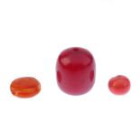 A selection of loose natural amber, coral and bakelite beads. The coral beads of mainly barrel shape