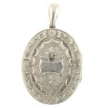 A late 19th century silver locket. Of oval outline, the front engraved with a fern motif and a